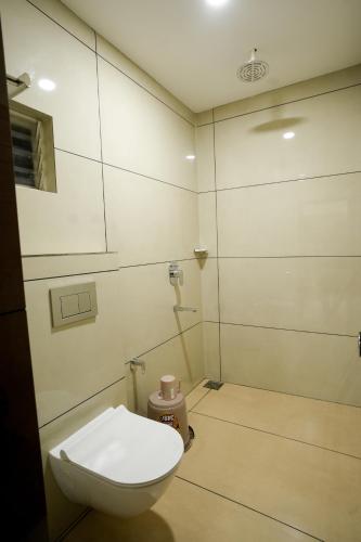 a bathroom with a toilet in a room at Grand View Residency in Nīleshwar