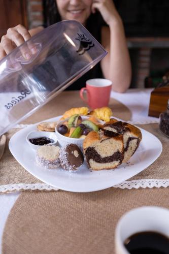 a plate of food on a table with a woman at Altillo Valizas in Barra de Valizas