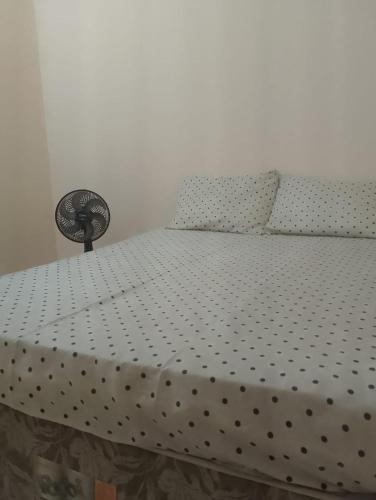 a bed in a room with a bedspread on it at Casa Brisa Tropical in Cayru