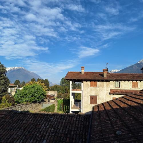 a view of a building with mountains in the background at Villa Viva-Como in Domaso