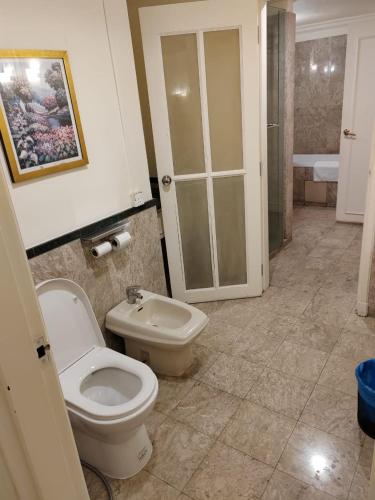 a bathroom with a toilet and a sink at The Times Square By Family Suites in Kuala Lumpur