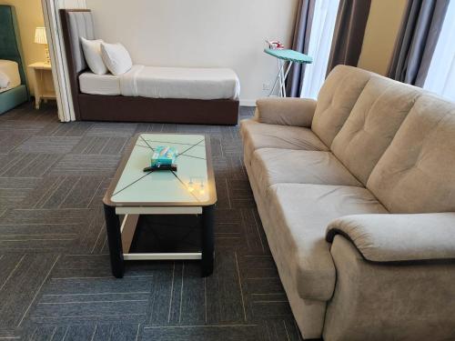 a living room with a couch and a coffee table at The Times Square By Family Suites in Kuala Lumpur