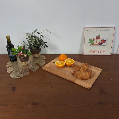a wooden table with a cutting board with oranges on it at Villa Viva-Como in Domaso