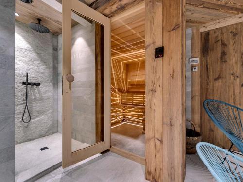 a room with a walk in shower and a glass door at Chalet 12 pers, Piscine, Hammam, Proche pistes, Val d'Isère - FR-1-567-129 in Val dʼIsère