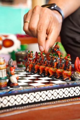 a person is playing chess on a chess board at Hotel and Country House Valle Sagrado de los Incas in Huaran