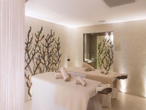 a bathroom with two sinks and a mirror at RMH Lopud Lafodia Resort & Wellness in Lopud Island