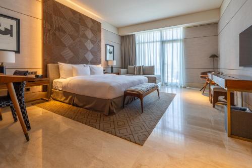 a hotel room with a bed and a desk at SHIRVAN Hotel City Yard Jeddah in Jeddah