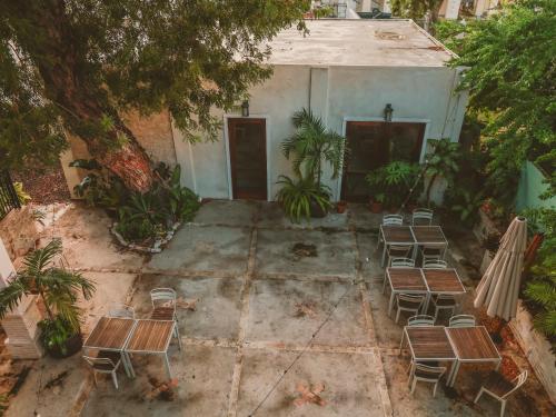 a group of chairs and tables in front of a building at Maison Rouge -Room 1 in Christiansted