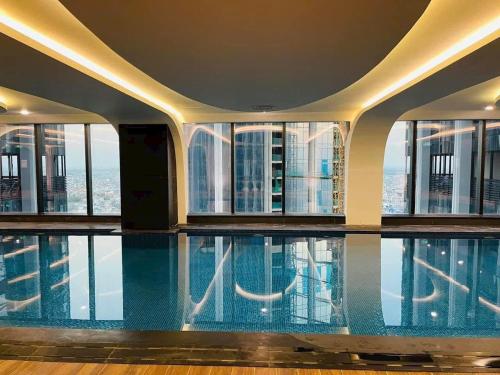 a swimming pool in the middle of a building with windows at Two bedrooms Apartment in Diamond Crown Hai Phong 2522 in Ðông Khê