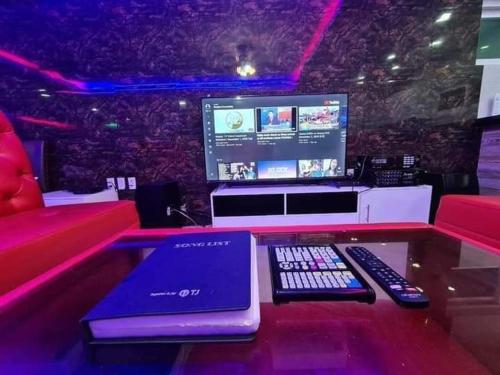a counter with a laptop and remote controls on it at Kara Villa in Angeles