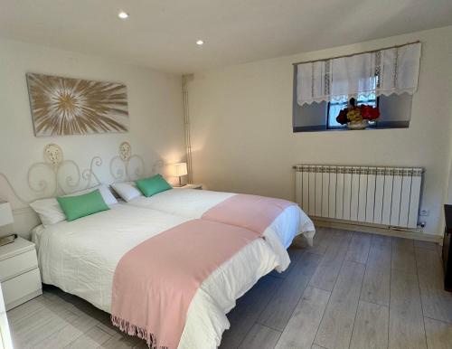 a bedroom with a large bed and a window at Casa Tía Milagros in Puebla de Sanabria