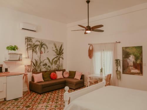 a living room with a bed and a couch at Maison Rouge - Room 2 in Christiansted
