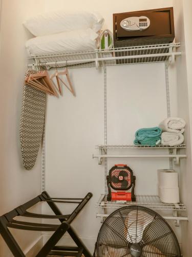 a room with white shelves and a fan at Maison Rouge - Room 2 in Christiansted