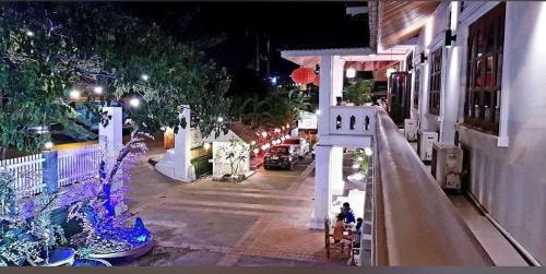 a street at night with a white cross on a building at ShuYa Hotel 舒雅酒店 in Luang Prabang