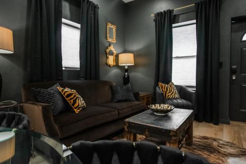 a living room with a couch and a table at Speakeasy Suite at ArnoTriplex! in Albuquerque