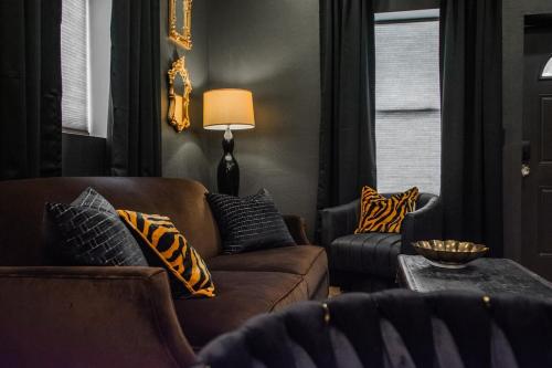 a living room with two couches and a table at Speakeasy Suite at ArnoTriplex! in Albuquerque