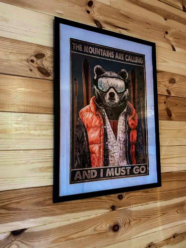 a picture of a dog in a gas mask hanging on a wall at Wooden house Durmitor in Žabljak