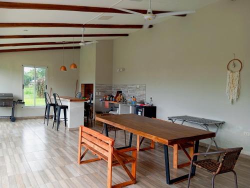 a living room with a wooden table and chairs at Quincho El Solar in Corrientes
