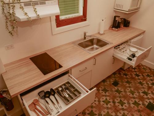 a small kitchen with a sink and a counter top at Maison Rouge - Room 3 in Christiansted