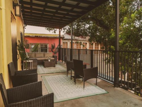 an outdoor patio with chairs and a table at Maison Rouge - Room 3 in Christiansted