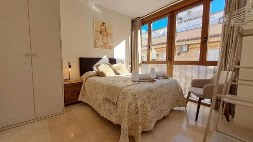 哈恩Suite Catedral Jaén的一间带床和大窗户的卧室