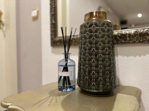 a black vase and a glass container on a table at Villa Burgau, C&H in Monschau