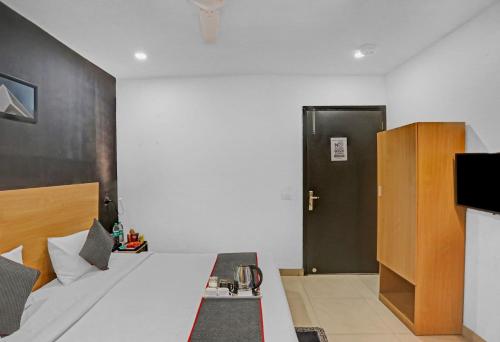 a bedroom with a bed and a black door at Townhouse Nangal Raya Pankha Road in New Delhi