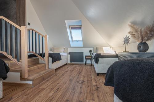 a room with a staircase and a bedroom with a bed at Dream Holiday z Sauna i jacuzzi Lovely Krynica Zdrój in Florynka