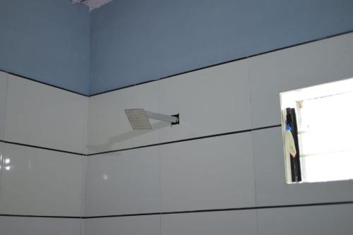 a room with a blue ceiling and a window at The dream gir farm in Junagadh