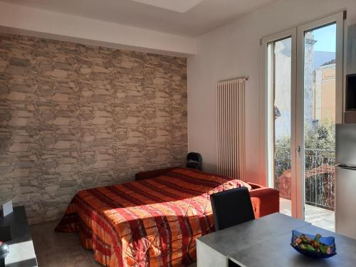 a bedroom with a bed and a table and a window at I 4 Leoni in Conversano