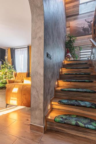 a room with a staircase with pillows on the floor at Dream Holiday z Sauna i jacuzzi Lovely Krynica Zdrój in Florynka