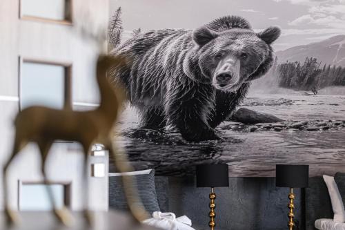 a painting of a grizzly bear crossing a river at Dream Holiday z Sauna i jacuzzi Lovely Krynica Zdrój in Florynka