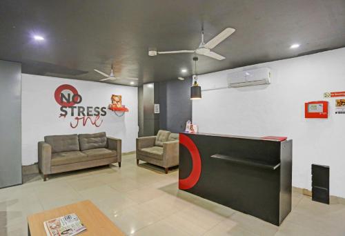 a waiting room with couches and a wall with graffiti at Townhouse Nangal Raya Pankha Road in New Delhi