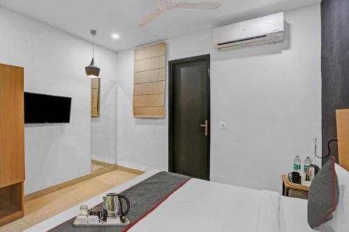a bedroom with a bed and a black door at Townhouse Nangal Raya Pankha Road in New Delhi