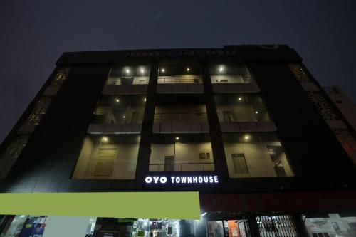 a building with a sign on the side of it at Townhouse Nangal Raya Pankha Road in New Delhi
