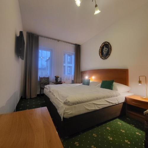a bedroom with a large bed and a window at Uśmiech Morza in Międzyzdroje