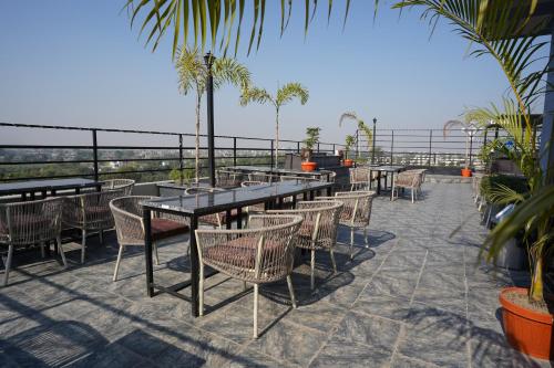 a patio with a table and chairs and the ocean at Hotel Faben Inn in Itahari