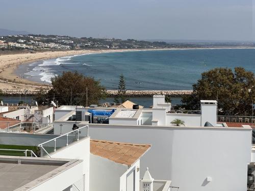 a view of a beach from a white building at Casa Paula Apartments in Lagos
