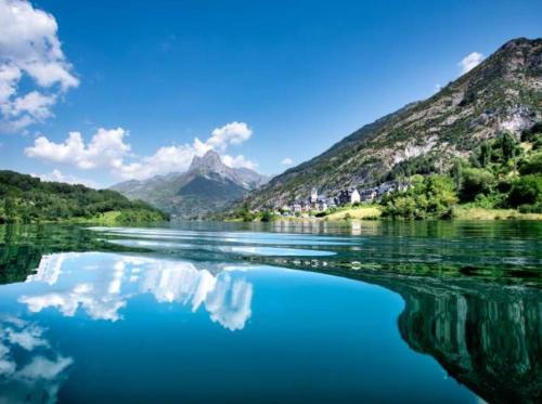 a large body of water with mountains in the background at EscarraSuite in Escarrilla
