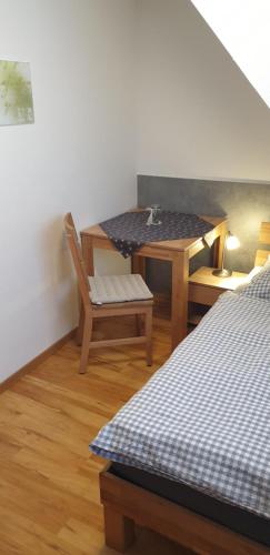 a room with a table and a table and a chair at Ferienwohnung "SCHÖNBUCH" , Pension Wauri in Waldenbuch