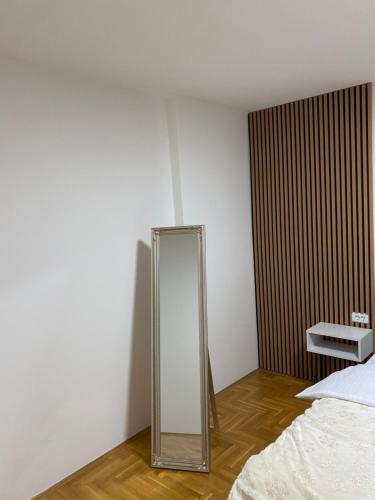 a mirror in the corner of a room with a bed at Pale apartman Gold in Pale