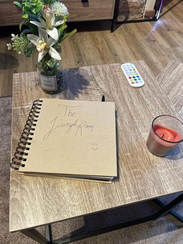 a notebook on a table with a happy birthday sign on it at La Jungle Room in Troyes