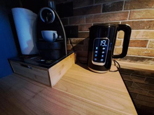 a coffee pot sitting on top of a wooden table at Frabosa Loft in Turin