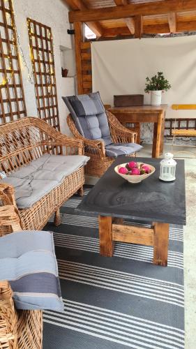 a patio with a table with a bowl of fruit on it at Petit Castel in Bran