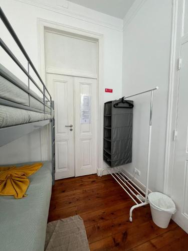 a bedroom with a bunk bed and a flat screen tv at Garden Campo de Ourique Guest House - Hostel in Lisbon