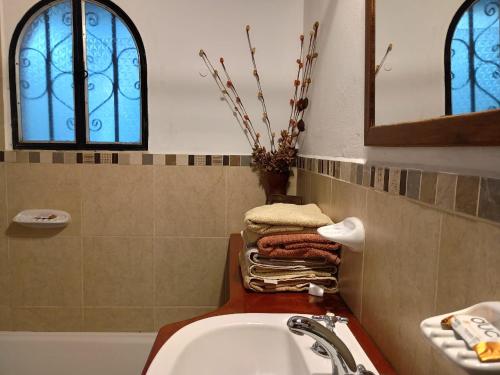 a bathroom with a sink and a toilet and a mirror at Monteverde in La Paz