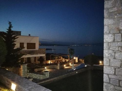 a house with a swimming pool at night at Malvazios Villas #3 in Gythio