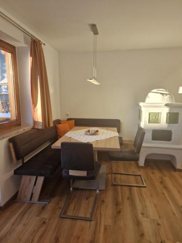 a living room with a table and a couch at Appartementhaus Hüttenberger in Erpfendorf
