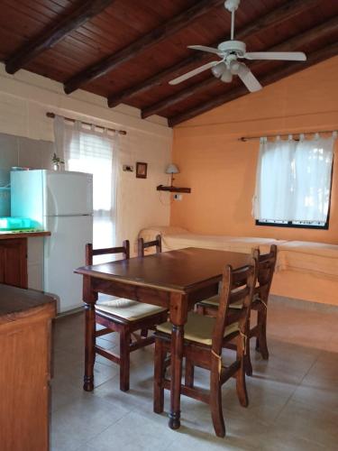 a kitchen with a table and chairs and a refrigerator at Monteverde in La Paz