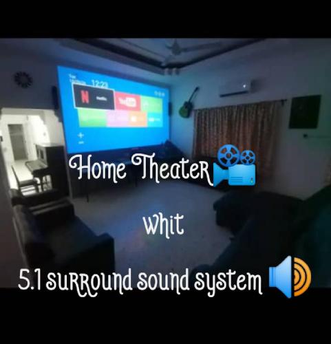 a living room with a television and a living room with a couch at Bergstein Taiping in Taiping